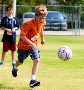 boy chasing ball in Gaelic football