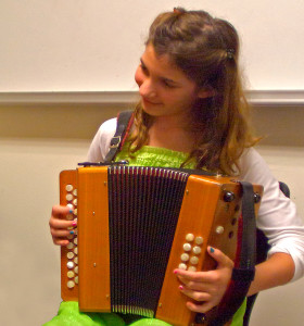 girl trying accordion