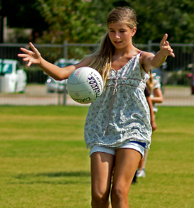 teenage girl practicing Gaelic football skills