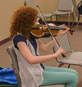 young lady fiddling