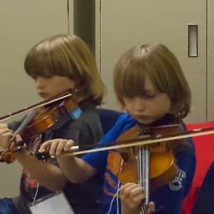 twin boys playing fiddle